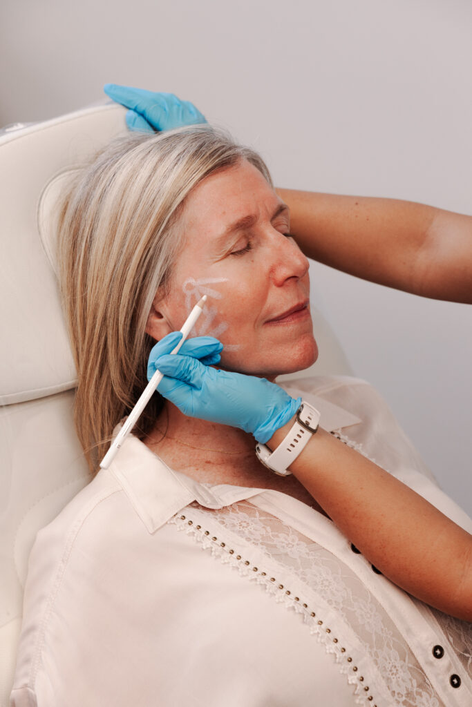 Rachel Friem participating in a branded facial treatment experience as part of Ethereal Med Spa’s marketing campaign while seated in a treatment chair