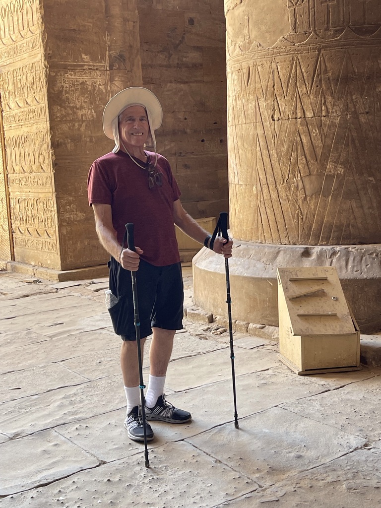 Rachel Friem’s father smiling with walking poles inside an ancient Egyptian temple