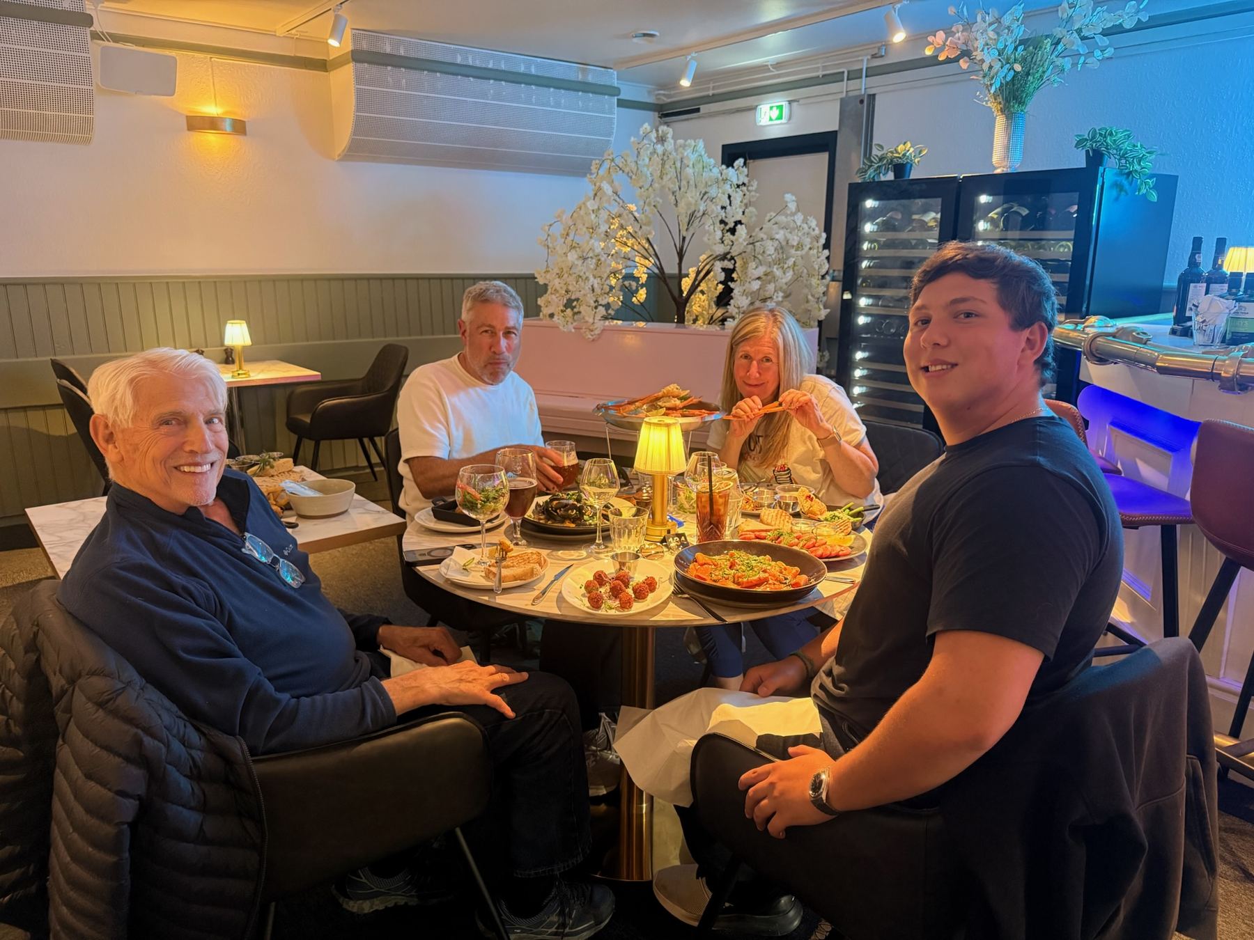 Family of four sharing seafood and king crab at Esme Lounge in Nuuk