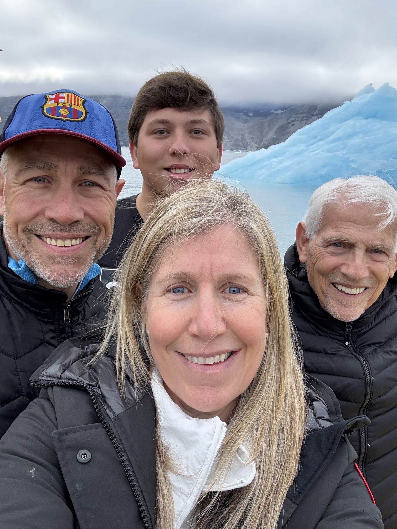 Rachel Friem with her dad and two brothers beside an iceberg in Nuuk Icefjord