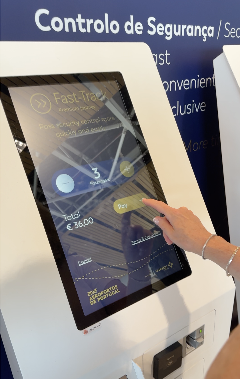 Traveler purchasing Fast Track security passes at Faro Airport